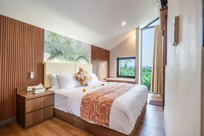 a bedroom with a large bed and a large window at Umaliving Villa Seminyak Bali in Seminyak