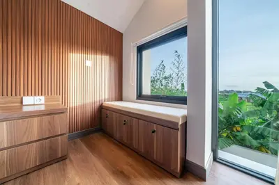 a window seat in a room with a large window at Umaliving Villa Seminyak Bali in Seminyak