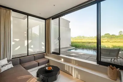 a room with a large window with a view of a field at Villa Mesra Stunning Paddy Fields Views - Canggu Berawa in Canggu