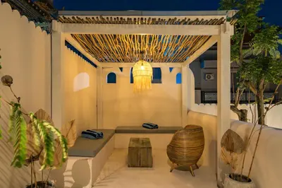 a pergola with a bench and a table at Villa Tibrava Umalas by BaliSuperHost in Canggu