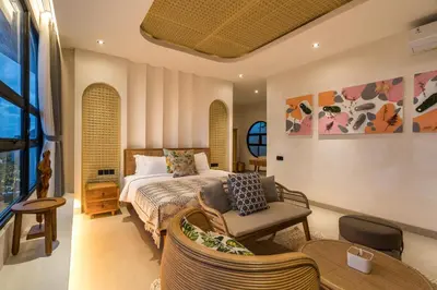 a bedroom with a bed and a chair at Villa Tibrava Umalas by BaliSuperHost in Canggu