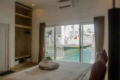 a bedroom with a bed and a view of a pool at Villa Orked 4 with 12 meter pool in Seminyak