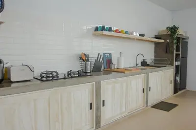a kitchen with wooden cabinets and a counter top at Villa Orked 4 with 12 meter pool in Seminyak