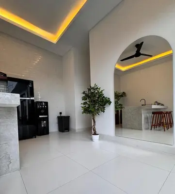 a living room with a ceiling fan and a plant at Private Escape in Seminyak in Seminyak