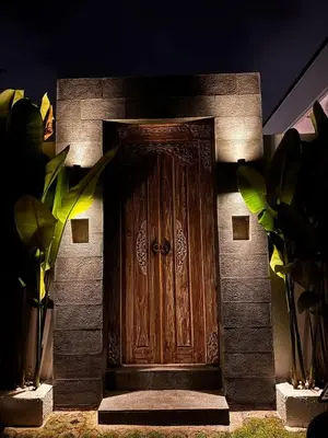 a wooden door on the side of a building at Private Escape in Seminyak in Seminyak