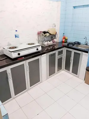 a kitchen with a stove and a counter top at Holiday Home Bali in Denpasar