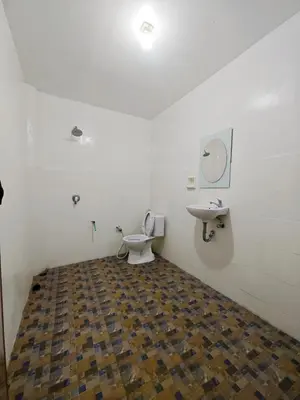 a bathroom with a toilet and a sink at Holiday Home Bali in Denpasar