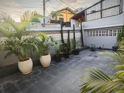 a courtyard with a bunch of plants in pots at Holiday Home Bali in Denpasar