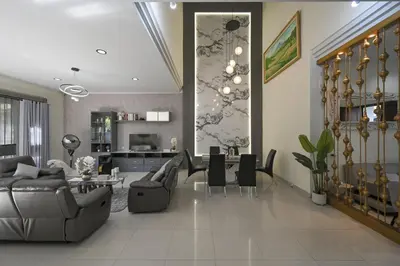 a living room with couches and a dining room at Puri Ratu Jimbaran with Private Pool in Jimbaran