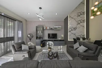 a living room with a couch and a table at Puri Ratu Jimbaran with Private Pool in Jimbaran