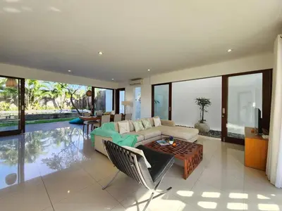 a living room with a couch and a table at Villa Abigail Seminyak by Nagisa Bali in Seminyak