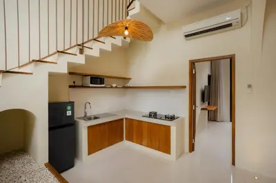 a kitchen with a sink and a staircase at Villa Batu Putih 2 Seminyak - No FLOOD in Seminyak