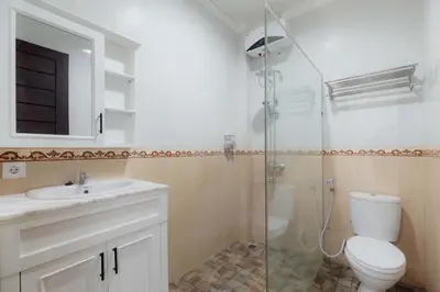 a bathroom with a toilet and a sink and a shower at Cherish Villa Umalas in Canggu