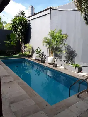 a swimming pool in a yard with plants at Seminyak great Location Villa in Seminyak