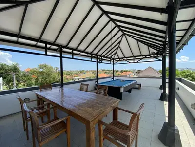 a patio with a ping pong table and chairs at Amazing Villa in Seminyak Petitenget Top Location in Seminyak