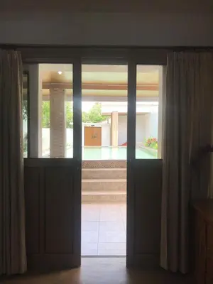 an open door with a view of a courtyard at One BedRoom Villa with Private Pool near DPS Airport in Kuta
