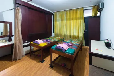 a room with a bed and two benches in it at One BedRoom Villa with Private Pool near DPS Airport in Kuta