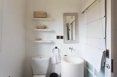 a bathroom with a white toilet and a sink at Bear Cottage 4 Bedroom Luxury Villa - Petitenget, Seminyak in Seminyak