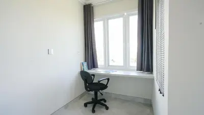 a chair in a room with a window at Rumah Jimbaran Kuta 3 bedroom 9 pax SukaBali 1 in Jimbaran
