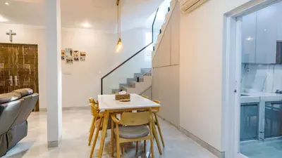 a small kitchen with a table and chairs and stairs at Rumah Jimbaran Kuta 3 bedroom 9 pax SukaBali 1 in Jimbaran