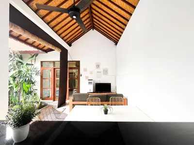 a living room with a couch and a ceiling at Villa Kita Seminyak in Seminyak