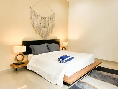 a bedroom with a large white bed and a chandelier at Villa Kita Seminyak in Seminyak