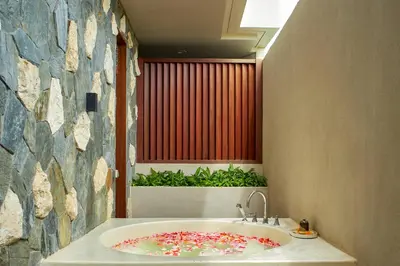 a bathroom with a sink with sprinkles on it at Aahana Village Bali in Canggu