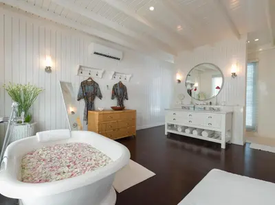 a white bathroom with a tub and a sink at Villa Lulito in Seminyak
