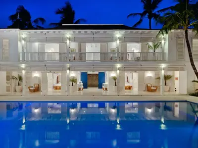 a villa with a swimming pool at night at Villa Lulito in Seminyak