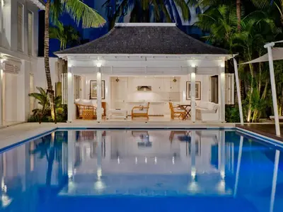 a swimming pool in front of a villa at Villa Lulito in Seminyak