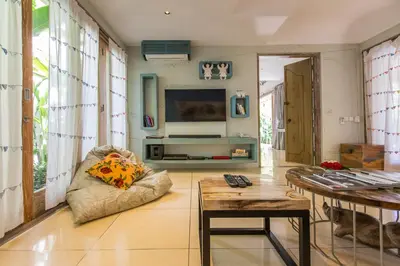 a living room with a couch and a table at Villa Sky Li by Nagisa Bali in Seminyak