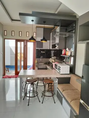 a kitchen with a table and some chairs in it at Villa Sanur2 in Sanur