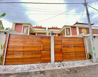 a wooden fence in front of a house at Villa Sanur 3 in Sanur