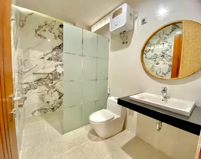 a bathroom with a toilet and a sink and a mirror at Villa Sanur 3 in Sanur