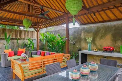 an outdoor patio with a table and chairs and a bench at Villa Bali Caviar in Seminyak
