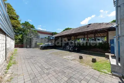 a building with a car parked in front of it at Ozz Hotel Kuta Bali manage by Ozz Group in Kuta