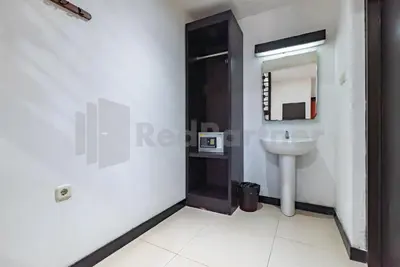 a bathroom with a sink and a mirror at Ozz Hotel Kuta Bali manage by Ozz Group in Kuta