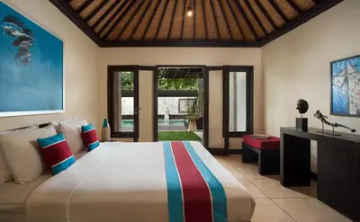 a bedroom with a large bed in a room at Villa Dewata II in Seminyak
