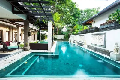 a swimming pool in the middle of a house at Villa Dewata II in Seminyak