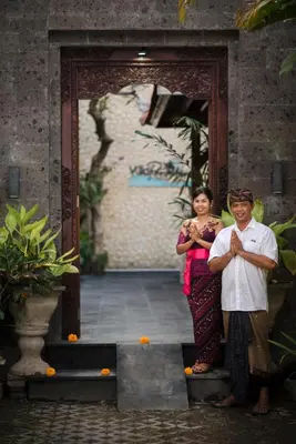 a man and a woman standing in front of a doorway at Villa Rendezvous Bali in Seminyak
