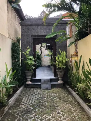 a walkway leading to a building with plants at Villa Rendezvous Bali in Seminyak