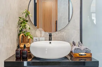 a bathroom with a white sink and a mirror at Kros Villa by Kozystay - Legian in Legian