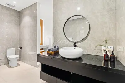 a bathroom with a sink and a mirror on a counter at Kros Villa by Kozystay - Legian in Legian