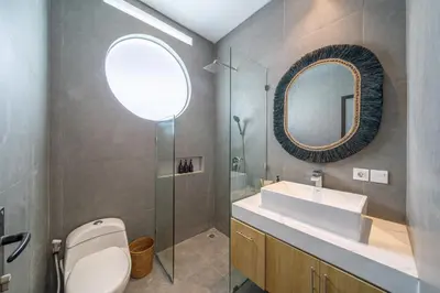 a bathroom with a toilet and a sink and a mirror at Sanjama - Unwind in Style - Brand New Villa with a Private Pool in Bali Best Location in Seminyak
