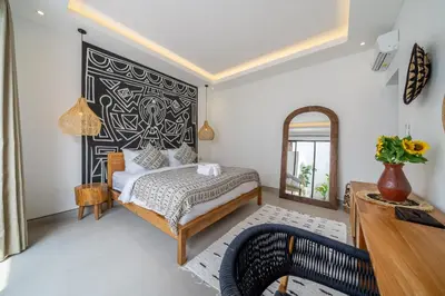 a bedroom with a bed with a black and white headboard at Sanjama - Unwind in Style - Brand New Villa with a Private Pool in Bali Best Location in Seminyak
