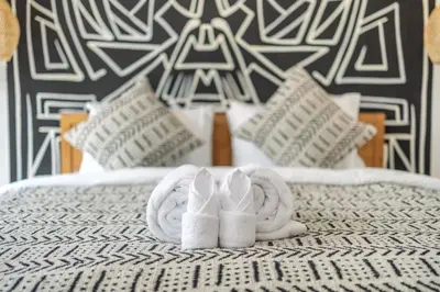 a pair of towels and slippers on a bed at Sanjama - Unwind in Style - Brand New Villa with a Private Pool in Bali Best Location in Seminyak
