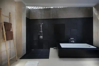 a black bathroom with a tub and a shower at Jayani Villa Seminyak byFaba in Seminyak