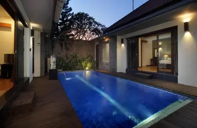 a swimming pool in the backyard of a house at Jayani Villa Seminyak byFaba in Seminyak
