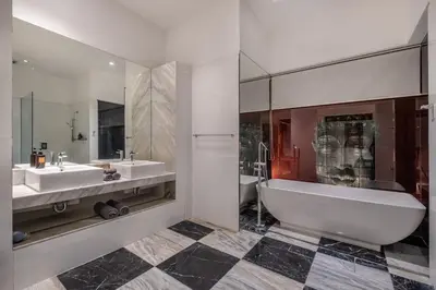 a bathroom with two sinks and a tub and a toilet at Villa Samudra Raya in Seminyak