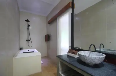 a bathroom with a sink and a large mirror at Zowa Villa Seminyak byFaba in Seminyak
